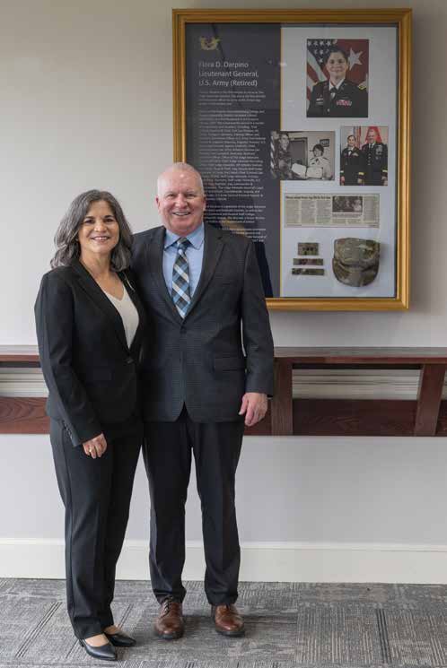 LTG (R) Flora D. Darpino and her husband, COL (R) Chris O’Brien, stand next to the newly unveiled display box in the regimental mess at TJAGLCS. (Credit: Billie Suttles, TJAGLCS)